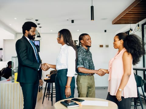 A group of people shaking hands in a room