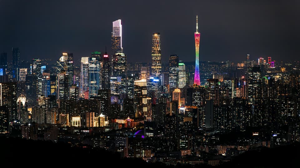 Vibrant cityscape illuminated at night with colorful lights