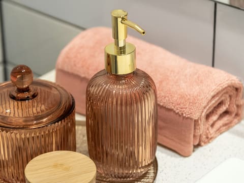 Bathroom Accessories: a bathroom sink with a soap dispenser and a soap dish