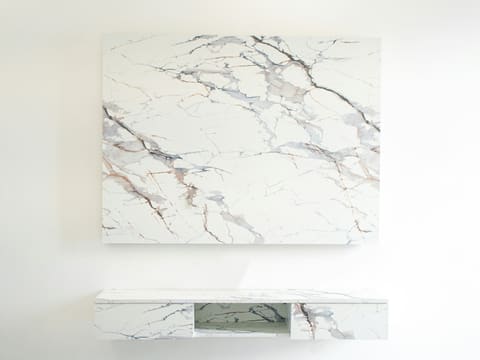 Bookmatch & Quadmatch Feature Walls: a painting on a wall next to a shelf