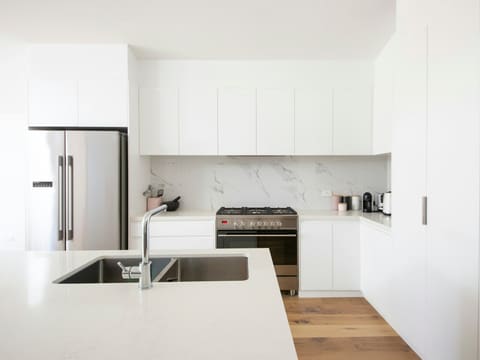 white wooden kitchen cabinet over white kitchen counter