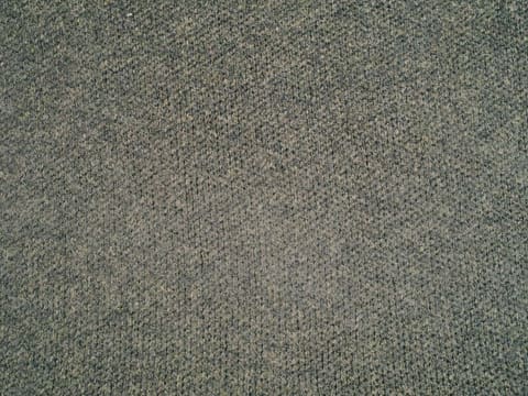 a close up of a gray carpet with a pattern