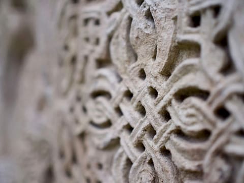 CNC Stone Carving, Columns & Balustrades: a close up of a stone wall with a pattern on it