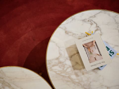 Coffee & Side Tables: two marble tables with a book on top