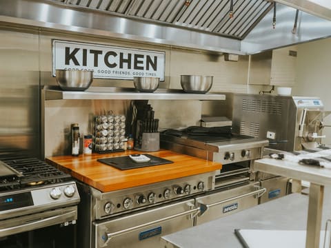 Commercial Kitchen Equipment: a kitchen with stainless steel appliances and a wooden counter