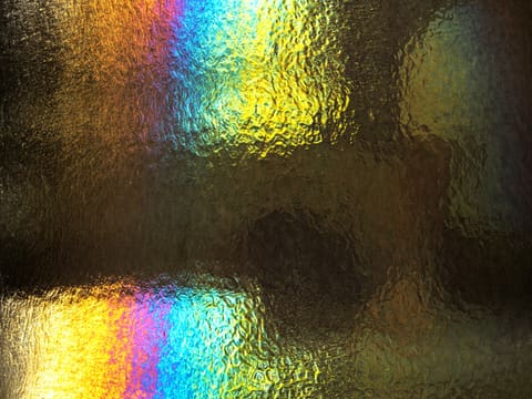 Iridescent & Dichroic Glass Panels: a close up of a window with a rainbow pattern on it