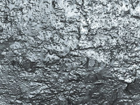 Electroplated Stone: a black and white photo of the surface of a wall