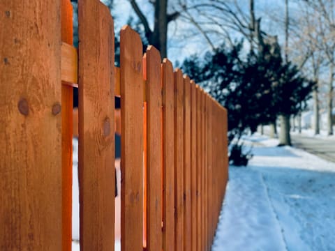 Fencing & Gates: a close up of a wooden fence in the snow