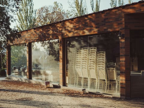 Folding & Bi-Fold Systems: a row of chairs sitting outside of a building