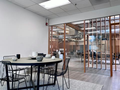 Glass Partitions & Office Systems: black metal table and chairs