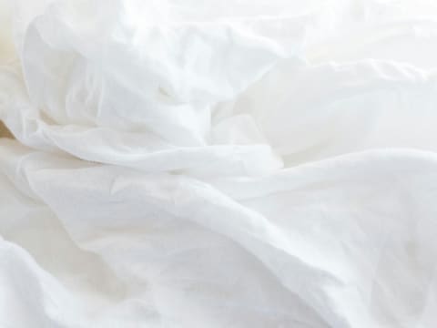 Bed Linen & Hotel Bedding Sets: a close up of a bed with white sheets