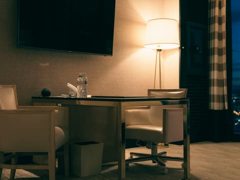 Hotel FF&E Casegoods: desk with chairs and lamp in a dimly lit room