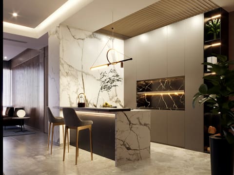 Modern kitchen island with marble accents and pendant light