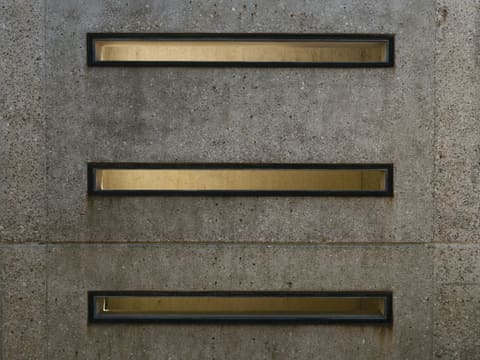 Custom Metal Reception & Bar Fronts: three rectangular openings are in a concrete wall