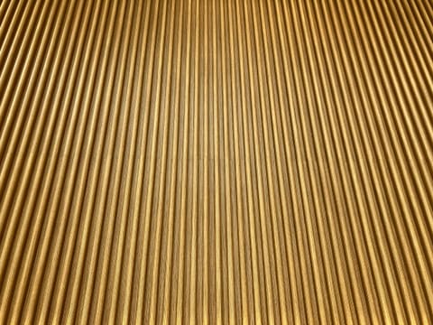 A fine textured surface with a uniform metallic gold finish