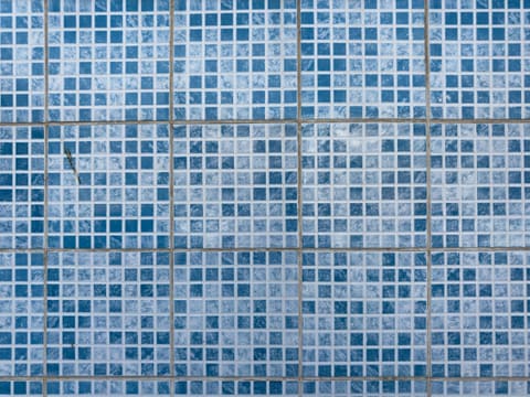 Mosaic (Glass, Stone, Metal): a blue tiled wall with a red stop sign