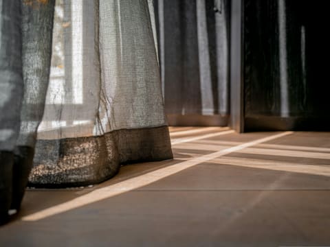 Motorised Curtain Tracks: a close up of a curtain on a window sill