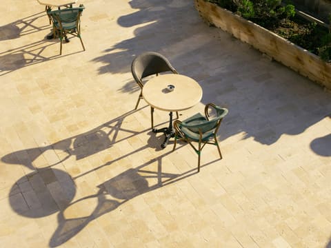 Outdoor Porcelain Pavers (20 mm): a couple of chairs and a table on a patio