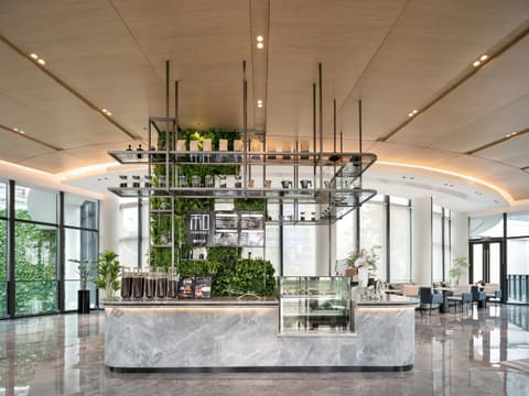 Reception & Bar Counters: modern coffee bar with lush greenery and marble counter