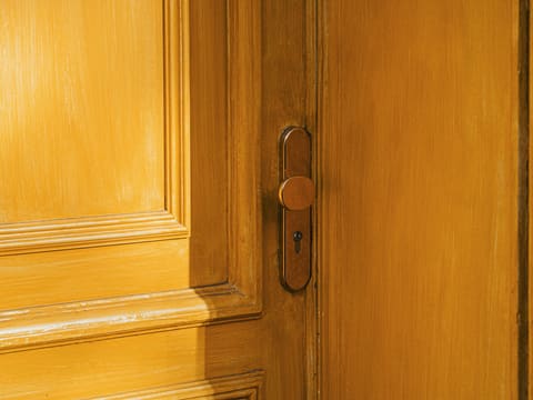 Solid Core & Veneer Doors: a close up of a door handle on a wooden door