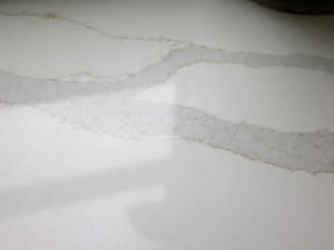 Stone Countertops & Vanity Tops: white countertop with subtle brown veining