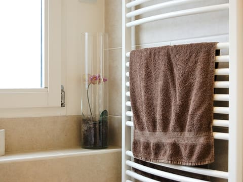 Towel Warmers: pink towel on white metal rack