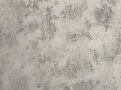 Venetian Plaster: a grey wall with a mottled and distressed plaster texture