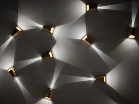 Wall Sconces: modern wall sconces casting light patterns on wall